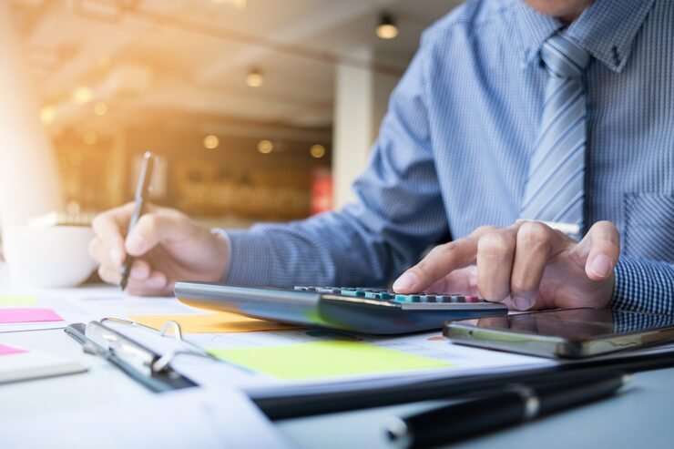 business finance-man calculating budget numbers invoices financial adviser working