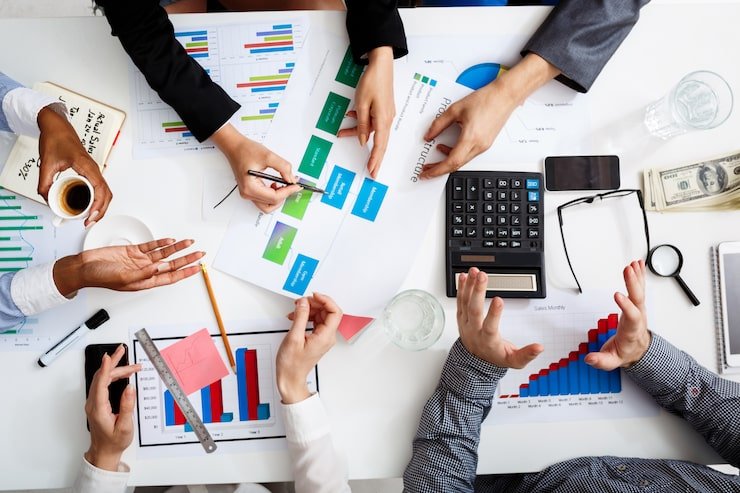 Close-up of businessmen working with documents on table