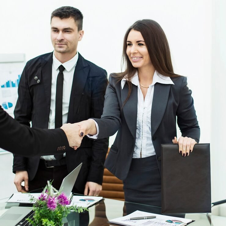 handshake business partners meeting near desktop modern office photo