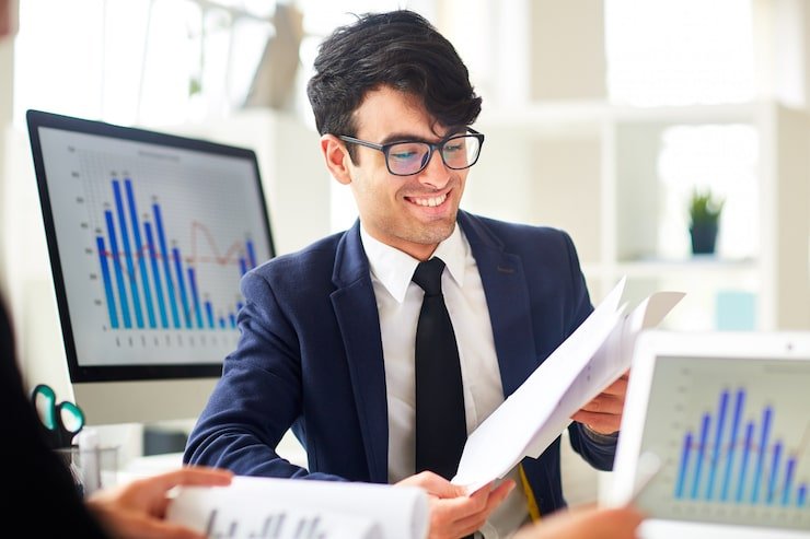 Accountant in Ashford reviewing financial papers and client accounts