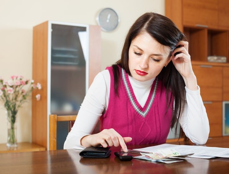 Woman filling out bills and utility payment documents
