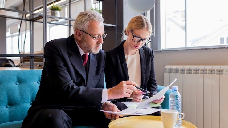 Tax accountant London UK discussing tax planning and filing strategies with a business client in the office